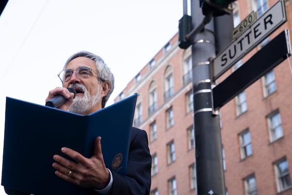 Supervisor Aaron Peskin pays respect during the street renaming to honor former AP photojournalist Joe Rosenthal, who won the Pulitzer Prize for his iconic photo of U.S. Marines raising the flag on the Japanese island of Iwo Jima during WWII, Thursday, Dec. 12, 2024, in San Francisco. (AP Photo/Minh Connors)