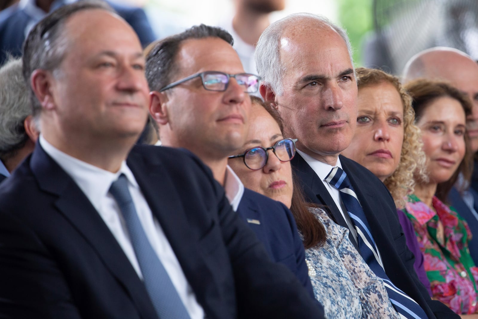 FILE - Second gentleman Doug Emhoff from left, Pennsylvania Governor Josh Shapiro, Carole Zawatsky, CEO of The Tree of Life, Sen. Bob Casey, Jr., D-Pa., Rep. Debbie Wasserman Schultz, D-Fla., and others listen during a groundbreaking ceremony for the new Tree of Life complex in Pittsburgh, Sunday, June 23, 2024. (AP Photo/Rebecca Droke)