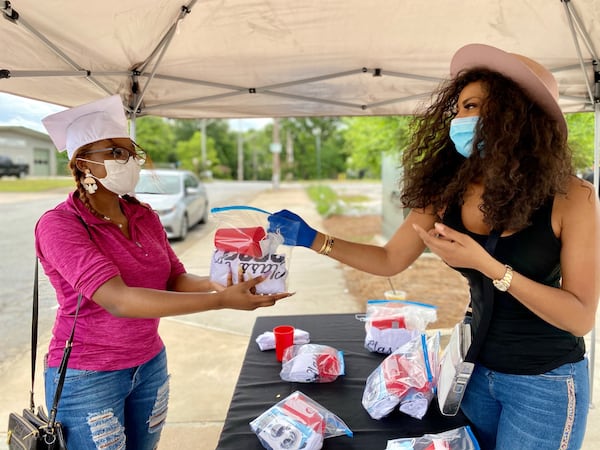 A 2020 graduate picks up her care package in College Park. CONTRIBUTED BY NOUVEAU BAR & GRILL