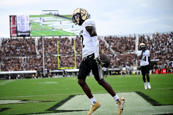 FILE - Colorado wide receiver Travis Hunter (12) celebrates his touchdown catch during the first half of an NCAA college football game against Central Florida, Saturday, Sept. 28, 2024, in Orlando, Fla. (AP Photo/Phelan M. Ebenhack, File)