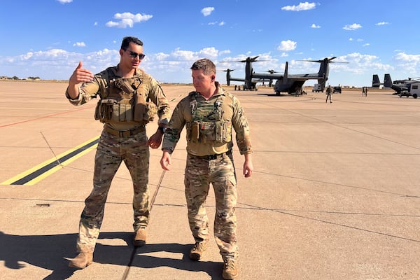 Osprey pilot Maj. Lucas Duncavage and squadron commander Lt. Col. Seth Buckley talk over their V-22 Osprey training flight just after landing, at Cannon Air Force Base, N.M., Oct. 9, 2024. During the flight they sped 100 feet off the ground on a training range named the Hornet. (AP Photo/Tara Copp)