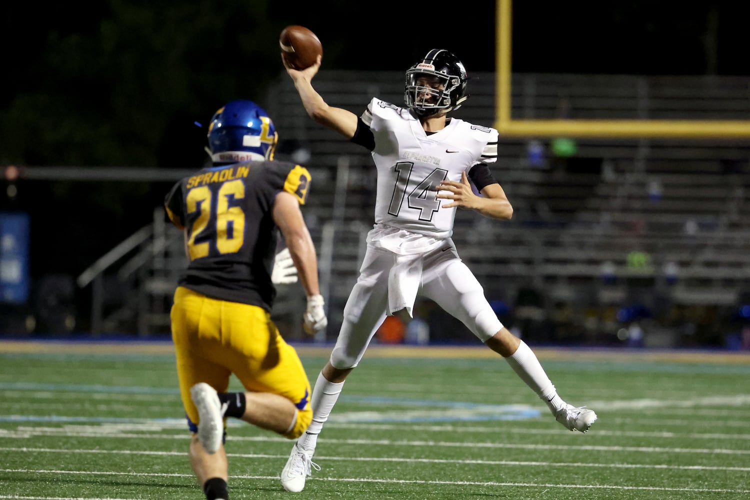 Alpharetta quarterback Walker Berryman (14) attempts a pass against Chattahoochee linebacker Billy Spradlin (26) in the first half at Chattahoochee high school Friday, September 25, 2020 in Johns Creek, Ga.. JASON GETZ FOR THE ATLANTA JOURNAL-CONSTITUTION