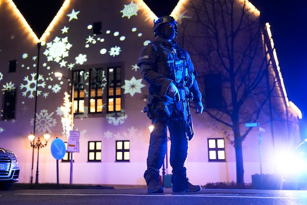 A police officer guards at a cordoned-off area near a Christmas Market after an incident in Magdeburg, Germany, Friday, Dec. 20, 2024. (AP Photo/Ebrahim Noroozi)