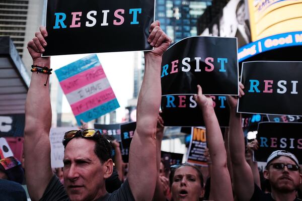 Dozens of protesters gather in Times Square near a military recruitment center to show their anger at President Donald Trump’s decision to reinstate a ban on transgender individuals from serving in the military on July 26, 2017, in New York City. Trump cited the “tremendous medical costs and disruption” for his decision. SPENCER PLATT / GETTY IMAGES