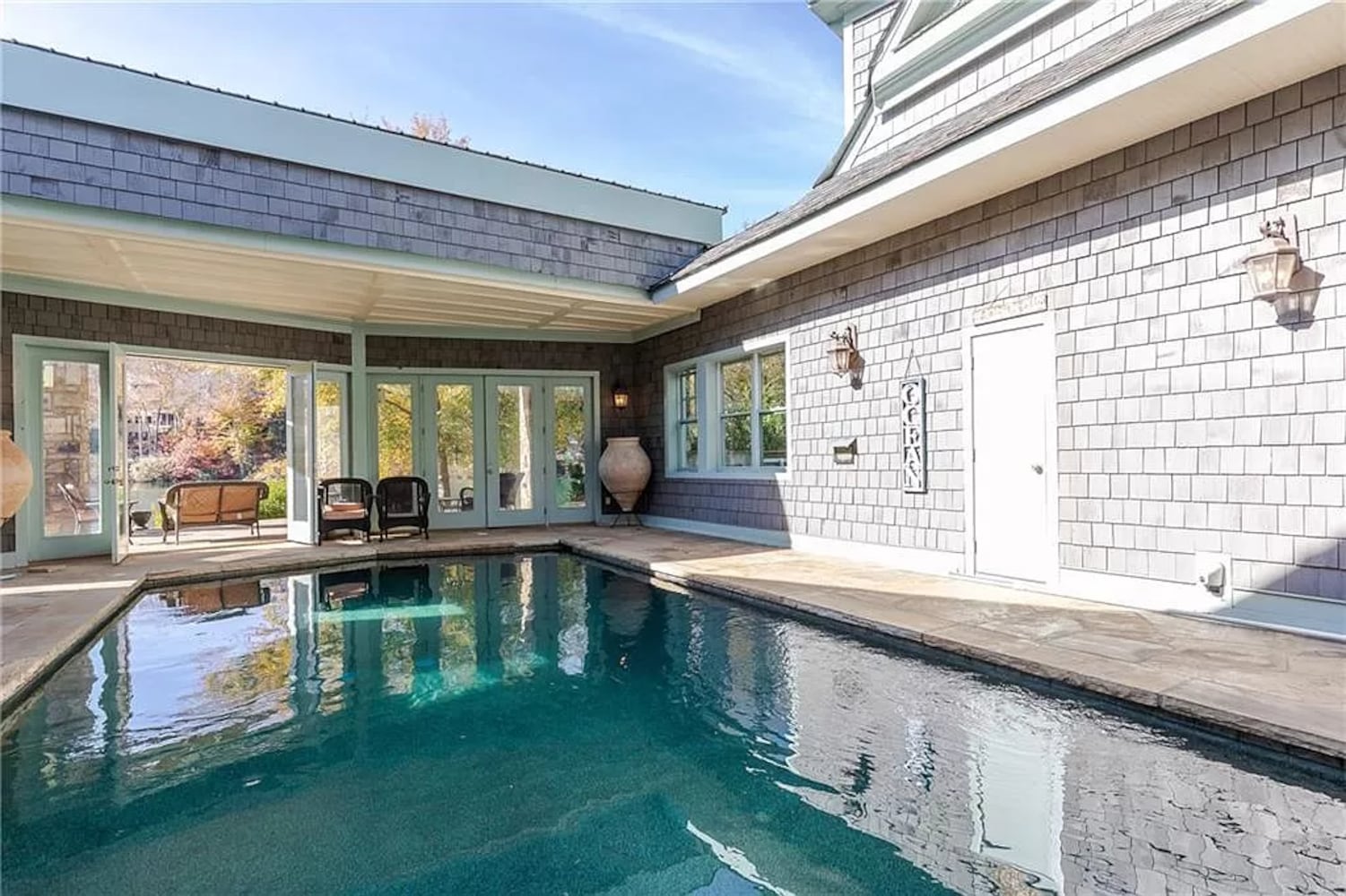 Enjoy resort-style living ITP at this $8.7M estate with private lake