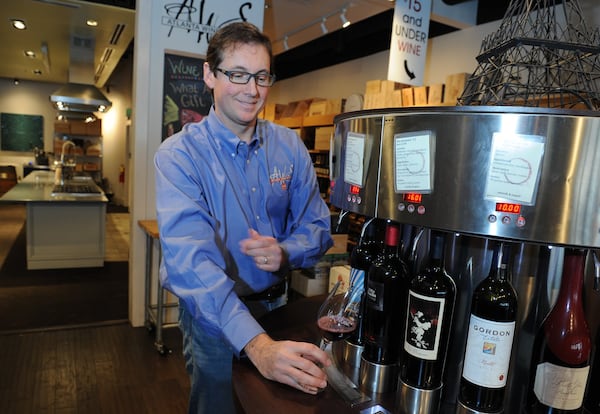 Vino Venue owner Michael Bryan at Vino venue in Dunwoody uses his Enomatic dispenser to allow customers try up to 32 different wines. (Beckysteinphotography.com)