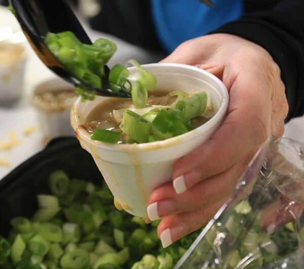 Cleveland Clinic Akron General serves its "Chill Bustin" white chili at the 11th Annual Akron Firefighters Chili Challenge at Lock 3 Park on January 20, 2017, in Akron, Ohio. From left are Lt. Sierjie Lash, Capt. Scott Pascu, and Firefighter Adam Lovell. (Phil Masturzo/Akron Beacon Journal/TNS)