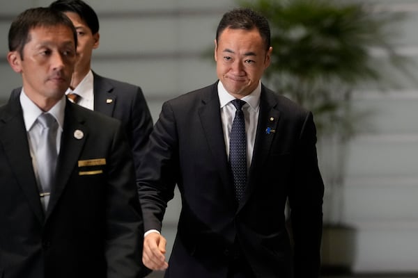 Keisuke Suzuki, newly appointed justice minister, walks at the prime minister's office Monday, Nov. 11, 2024, in Tokyo. (AP Photo/Shuji Kajiyama)