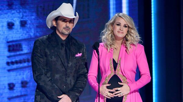 Brad Paisley and Carrie Underwood speak onstage during the 52nd annual CMA Awards. Underwood revealed she is having a second son on the show.