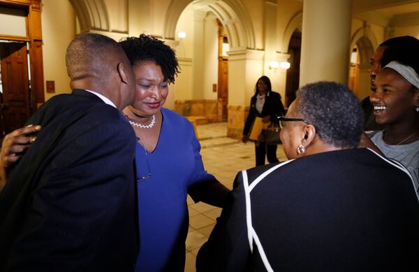 Stacy Abrams is surprised by her parents, the Revs. Robert and Carolyn Abrams, as she arrives to qualify to run as a Democratic candidate for governor. BOB ANDRES /BANDRES@AJC.COM