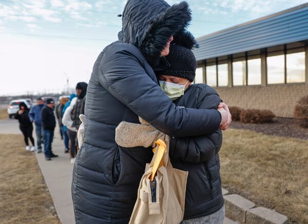 FILE - Jonna Higgins-Freese, left, of Iowa City, Iowa, hugs a woman waiting for her immigration check-in outside of the U.S. Immigration and Customs Enforcement office in Cedar Rapids, Iowa, Feb. 4, 2025. (Jim Slosiarek/The Gazette Via AP, File)