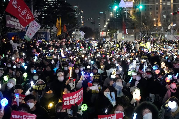 Participants stage a rally to demand South Korean President Yoon Suk Yeol's impeachment, outside the National Assembly in Seoul, South Korea, Wednesday, Dec. 11, 2024. (AP Photo/Ahnn Young-joon)