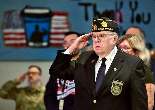 U.S. Army veteran Terry Sloan, of Ebensburg, salutes during the playing of the national anthem at the beginning of the Veteran's Day Breakfast event at Greater Johnstown Middle School in Johnstown, Pa., Thursday, Nov. 7, 2024. (Thomas Slusser/The Tribune-Democrat via AP)