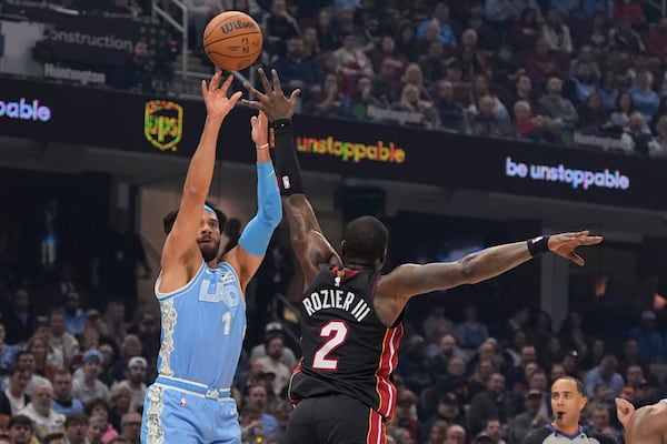 Cleveland Cavaliers guard Max Strus (1) shoots over Miami Heat guard Terry Rozier (2) in the first half of an NBA basketball game Wednesday, March 5, 2025, in Cleveland. (AP Photo/Sue Ogrocki)