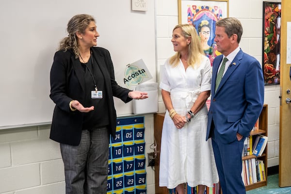 Ola High School's Dorcas Toledo-Acosta talks with Gov. Brian Kemp and first lady Marty Kemp after a press conference at Ola High School in Henry County on Friday, July 29, 2022. (Steve Schaefer / steve.schaefer@ajc.com)