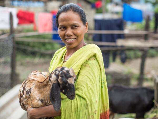 Dhan Kumari Mahato poses with one of her goats in Nepal. The goat was provided by Heifer International, an aid organization that has placed a quarter million animals with families in developing countries. CONTRIBUTED: HEIFER INTERNATIONAL