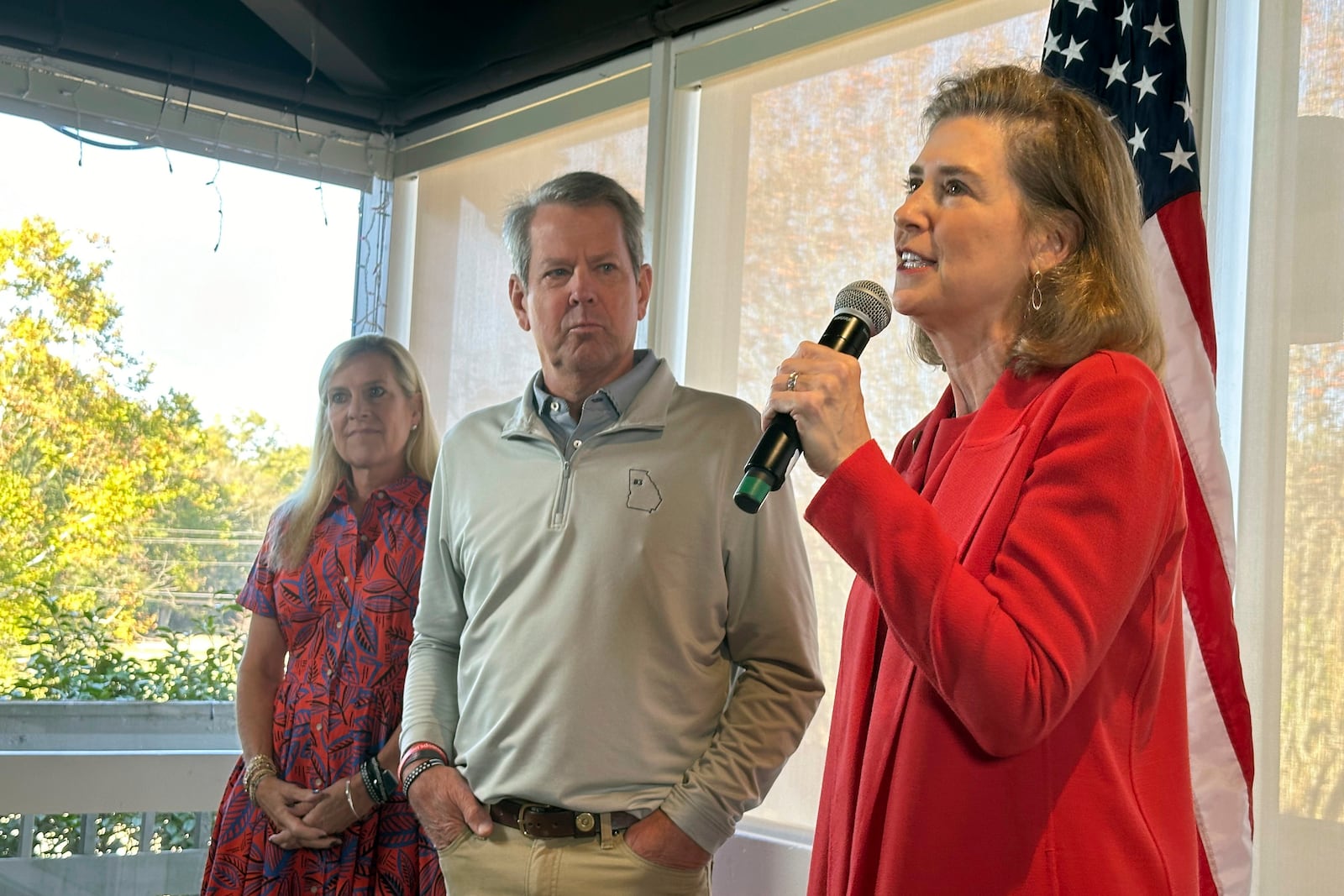 Georgia state Rep. Deborah Silcox (right) R-Sandy Springs, speaks at a campaign event as Georgia Gov. Brian Kemp and first lady Marty Kemp, listen on Friday, Oct. 25, 2024, in Atlanta.