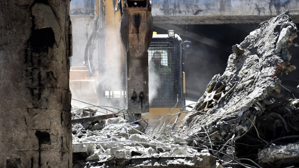 April 1, 2017 Atlanta - Crews demolish a damaged section of I-85 bridge structures on Saturday, April 1, 2017. Necessary work is continuing on the damaged sections of I-85 bridge structures. This includes demolition of the existing failed and damaged structures - which includes two 350-foot sections of interstate, one section each in both the northbound and southbound lanes, totaling approximately 700 feet - as well as all reconstruction activities. HYOSUB SHIN / HSHIN@AJC.COM