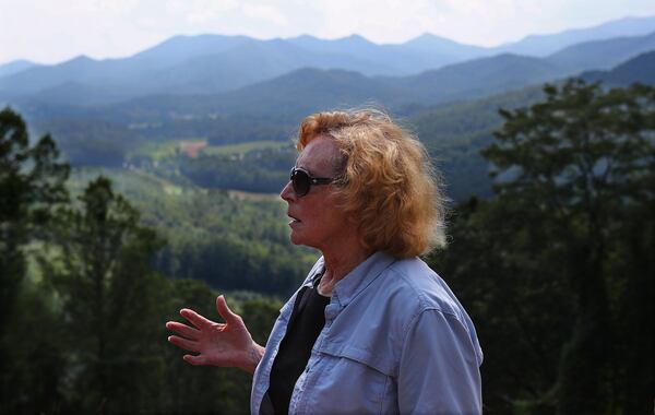 Hiker and nature lover Brenda Smith looks over the Nantahala range and the town of Dillard from the Sky Valley Overlook, where she goes most evenings to watch the sun set with her dog. CURTIS COMPTON / CCOMPTON@AJC.COM