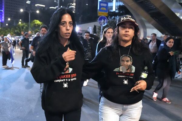 Einav Zangauker, left, mother of Israeli hostage Matan Zangauker and his partner Ilana Gritzewsky protest following a Hamas video release of Matan making an emotional plea for his release and describing the conditions he and other hostages face in Gaza after being seized in the Oct. 7 attack, in Tel Aviv, Israel, Saturday, Dec. 7, 2024. (AP Photo/Mahmoud Illean)