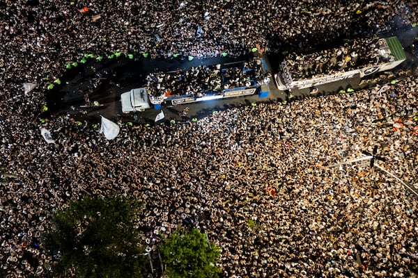 Players of Brazil's Botafogo parade through the streets on a truck during a homecoming celebration after winning the Copa Libertadores soccer tournament, in Rio de Janeiro, Sunday, Dec. 1, 2024. (AP Photo/Bruna Prado)