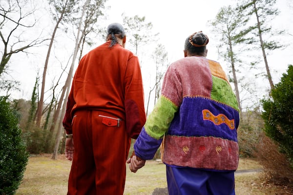 Morocco and Paula Coleman hold hands as they contemplate the view outside their house on Wednesday, Feb 1, 2023. Miguel Martinez / miguel.martinezjimenez@ajc.com