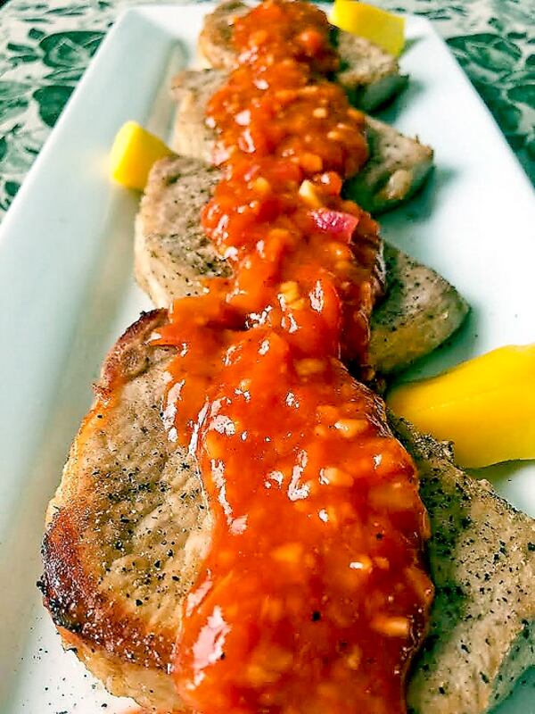 Pork chops with spicy mango barbecue sauce. (Karen Kane/Pittsburgh Post-Gazette/TNS)