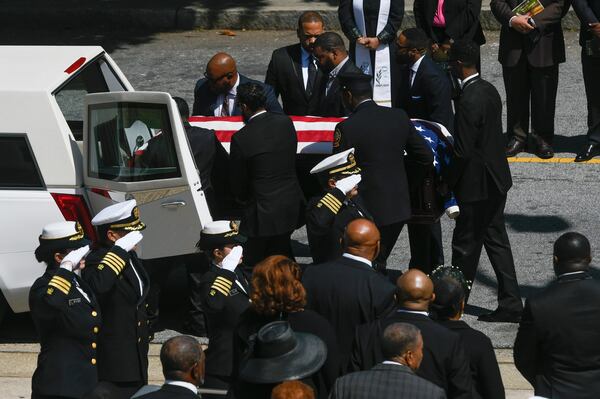 A CDC honor guard salutes as CDC researcher Timothy Cunningham is loaded into a hearse with family members looking on at lower right during a memorial service held Saturday at Morehouse April 21, 2018. Cunningham was found in the Chattahoochee River after being missing for seven weeks. (John Amis Contributed)