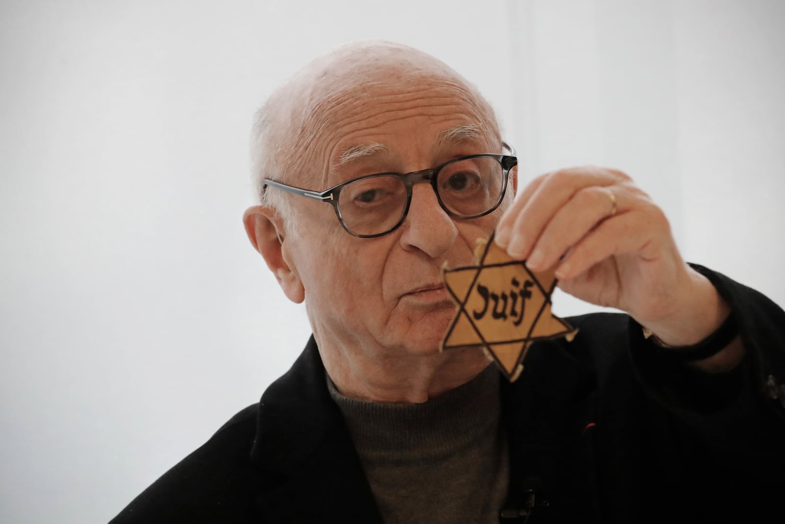 FILE - Victor Perahia, who was interned as a child in the Drancy camp and deported to Bergen-Belsen speaks to students during a workshop dedicated to the Holocaust remembrance at the Drancy Shoah memorial, outside Paris, Thursday Jan. 30, 2020. Victor Perahia, the president of the French Union of Auschwitz Deportees and a Holocaust survivor, has died. He was 91. (AP Photo/Christophe Ena, File)