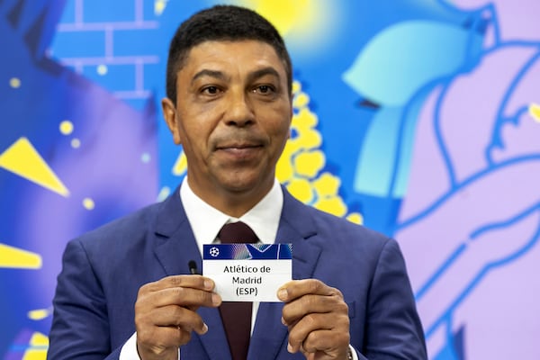 Brazilian former player Giovane Elber shows the ticket of Spanish club Atletico de Madrid, during the UEFA Champions League round of 16, quarter-final and semi-final draws, at the UEFA headquarters in Nyon, Switzerland, Friday, Feb. 21, 2025. (Salvatore Di Nolfi/Keystone via AP)