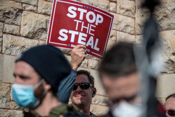 01/06/2021 — Atlanta, Georgia — A man holds a sign during a ‘Stop the Steal’ rally outside of the Georgia State capital building in downtown Atlanta, Wednesday, January 6, 2021. (Alyssa Pointer / Alyssa.Pointer@ajc.com)