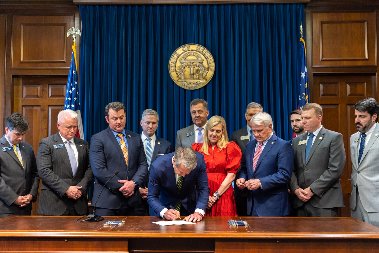 Gov. Brian Kemp signs a bill Wednesday to allow a state-appointed commission to discipline or remove locally elected district attorneys.