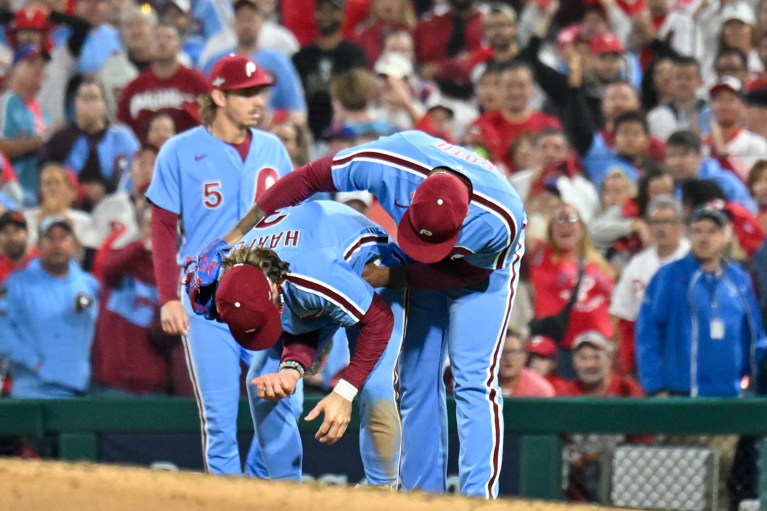 Philadelphia Phillies first baseman Bryce Harper, center, is consoled by relief pitcher Gregory Soto (30) after colliding with Atlanta Braves’ baserunner Matt Olson during the eighth inning of NLDS Game 4 at Citizens Bank Park in Philadelphia on Thursday, Oct. 12, 2023.   (Hyosub Shin / Hyosub.Shin@ajc.com)