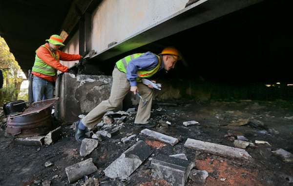 GDOT bridge inspectors, Jeramy Durrence (left) and Andy Doyle (right) make an inspection in Atlanta on Oct. 10, 2012. JOHN SPINK / AJC