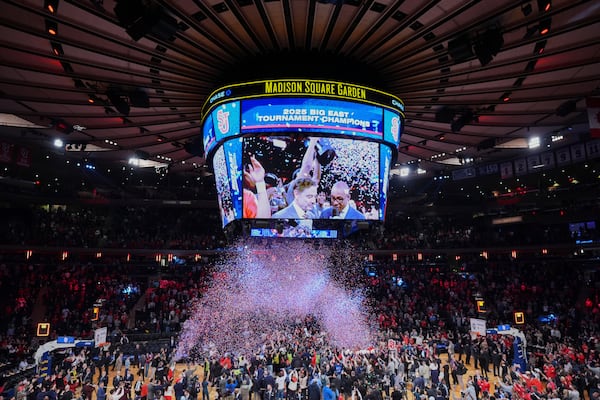 Fans watch as St. John's celebrates during the trophy ceremony after an NCAA college basketball game against Creighton in the championship of the Big East Conference tournament Saturday, March 15, 2025, in New York. (AP Photo/Frank Franklin II)