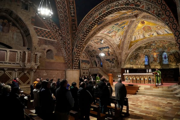 Faithful attend a mass inside St. Francis Basilica in Assisi, Italy, Saturday, March 1, 2025. (AP Photo/Gregorio Borgia)