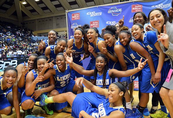 MARCH 8, 2014 MACON McEachern Indians players and their head coach Phyllis Arthur (right) celebrate during the awards ceremony after the game. Coverage of the Class AAAAAA girls basketball championship between the McEachern Indians and Archer Tigers at the Macon Coliseum Saturday, March 8, 2014. McEachearn won, beating Archer, 81-62 . KENT D. JOHNSON / KDJOHNSON@AJC.COM McEachern players celebrate their Class AAAAAA championship win over Archer Saturday, March 8, 2014, in Macon. (Kent D. Johnson / AJC)