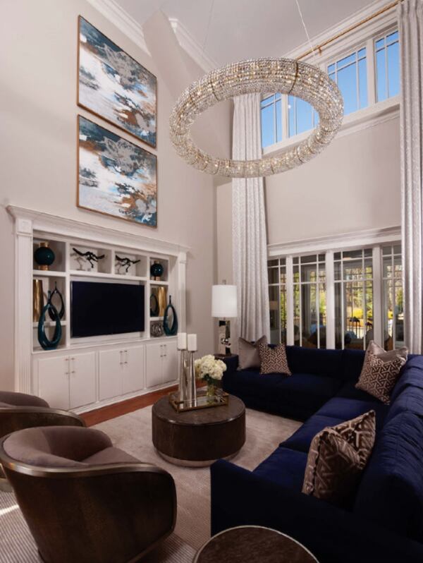 The living room features a 70's crystal "Halo" chandelier and a navy blue velvet sectional.