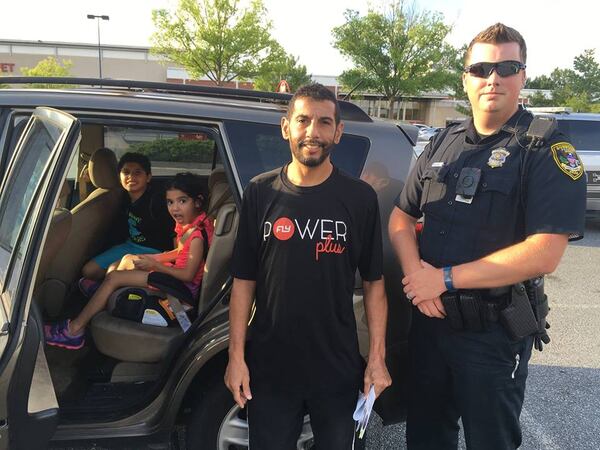 Dunwoody police Officer Jeffrey Leach (right) allowed the driver of an SUV to buy a car seat at Target for his youngest child rather than writing him a ticket. (Credit: Dunwoody Police Department)