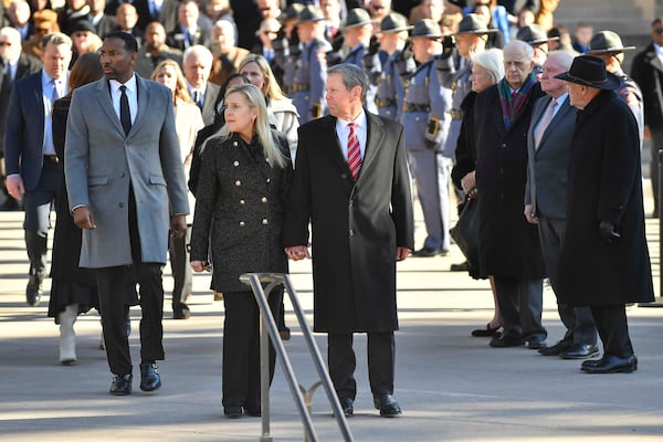 Atlanta Mayor Andre Dickens (left), Georgia First Lady Marty Kemp, her husband, Gov. Brian Kemp, and former governors Roy Barns, Sonny Purdue, and Nathan Deal are seen during a ceremonial pause at the Georgia State Capitol building in downtown Atlanta on Saturday, Jan. 4, 2025. (Daniel Varnado/For the AJC)