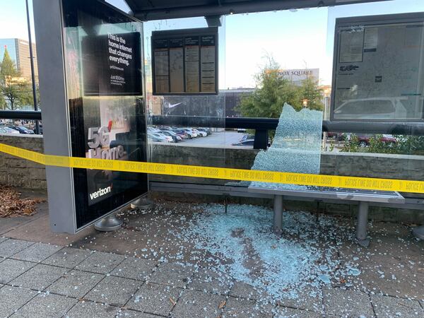 Bullets from a shooting that erupted inside the new Apple store in Lenox Mall shattered the windows of a MARTA bus stop across the street Friday afternoon. Credit: ADA WOOD / ADA.WOOD@AJC.COM