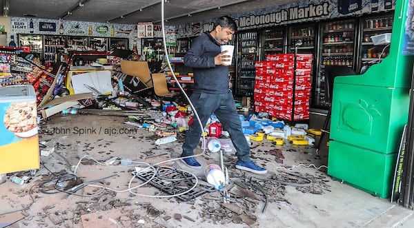 Store manager Tony Patel surveys the damage at McDonough Market on Macon Street after a car plowed through the store. “I feel lucky no one was hurt,” he said.