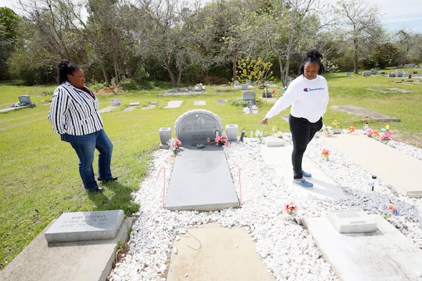 The children of Ruthie Richardson visit their mother's gravesite in Tifton. Richardson was killed in her front yard when a trooper performed a PIT maneuver on a fleeing vehicle, causing it to lose control and careen onto Richardson's property. (Miguel Martinez /miguel.martinezjimenez@ajc.com)