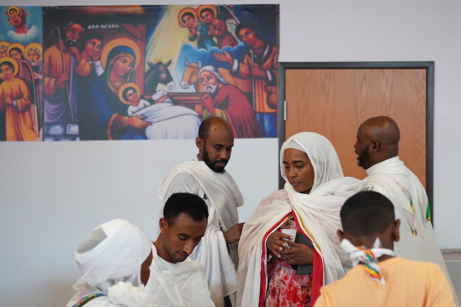 Members of the Ethiopian Orthodox Tewahedo Church visit after service on Sunday, Oct. 20, 2024, in Worthington, Minn. (AP Photo/Jessie Wardarski)