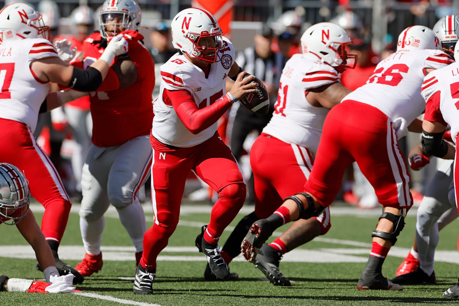 Nebraska quarterback Dylan Raiola scrambles away from Ohio State defenders during the first half of an NCAA college football game Saturday, Oct. 26, 2024, in Columbus, Ohio. (AP Photo/Jay LaPrete)