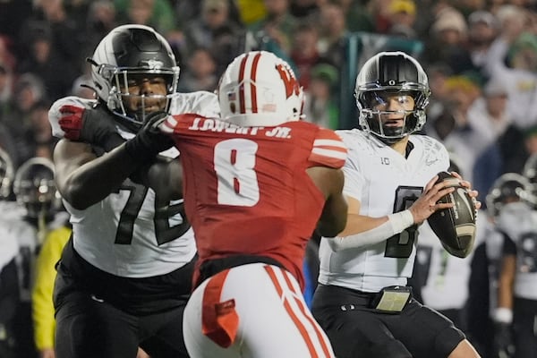 Oregon's Dillon Gabriel (8) looks to throw during the second half of an NCAA college football game against Wisconsin Saturday, Nov. 16, 2024, in Madison, Wis. Oregon won 16-13. (AP Photo/Morry Gash)