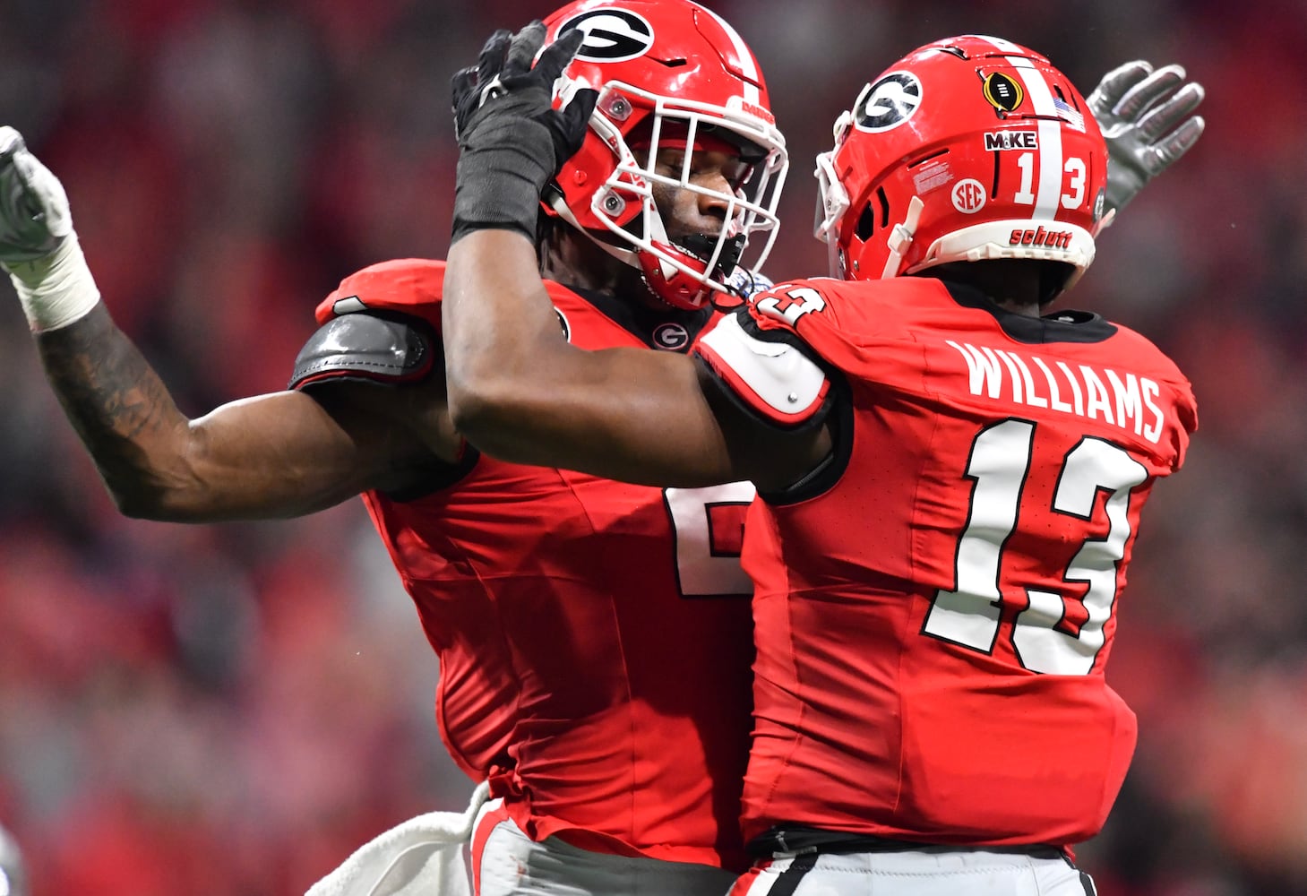 Georgia Bulldogs defensive lineman Mykel Williams (13) celebrates with linebacker Smael Mondon Jr. (2) after Williams sacked Ohio State Buckeyes quarterback C.J. Stroud (7) during the second quarter. (Hyosub Shin / Hyosub.Shin@ajc.com)