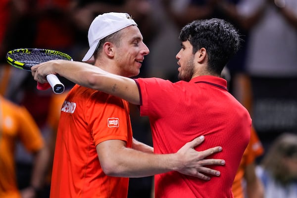 Spain's tennis player Carlos Alcaraz hugs Netherlands' Tallon Griekspoor after a Davis Cup quarterfinal match at Martin Carpena Sports Hall in Malaga, southern Spain, on Tuesday, Nov. 19, 2024. (AP Photo/Manu Fernandez)