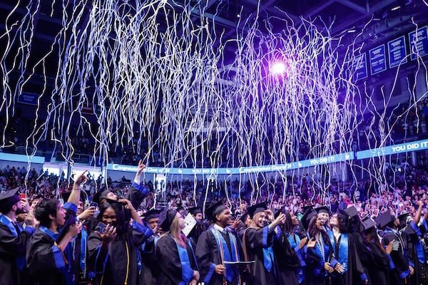 Streamers fall from the ceiling at the conclusion of the Georgia State University J. Mack Robinson College of Business morning graduation ceremony at the Georgia State Convocation Center in Atlanta on Thursday, May 2, 2024. (Natrice Miller/ AJC)