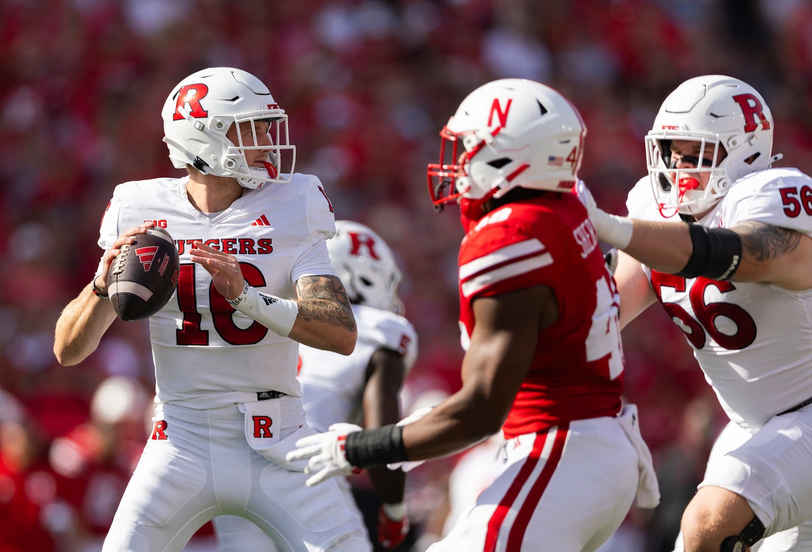 Rutgers quarterback Athan Kaliakmanis, left, sets up a pass against Nebraska during the first half of an NCAA college football game Saturday, Oct. 5, 2024, in Lincoln, Neb. (AP Photo/Rebecca S. Gratz)